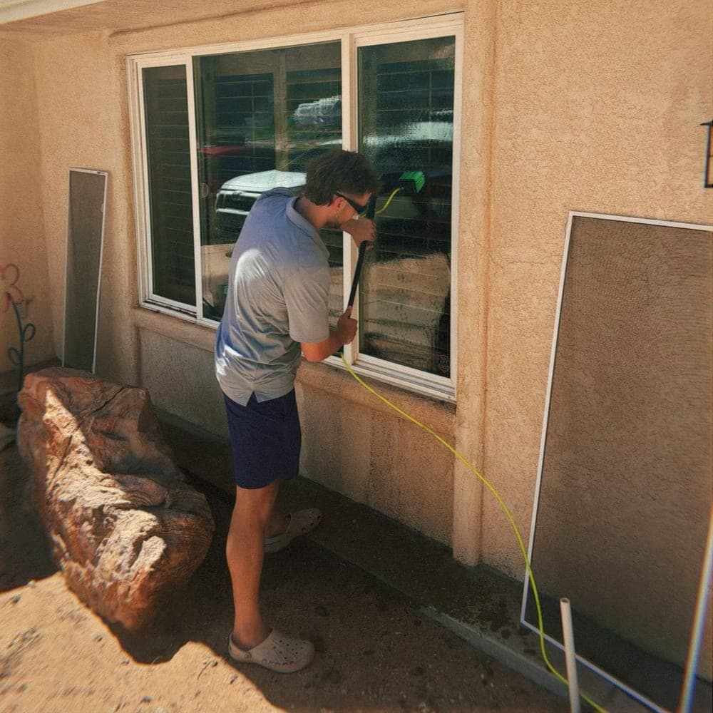 Technician mid-clean on a residential window